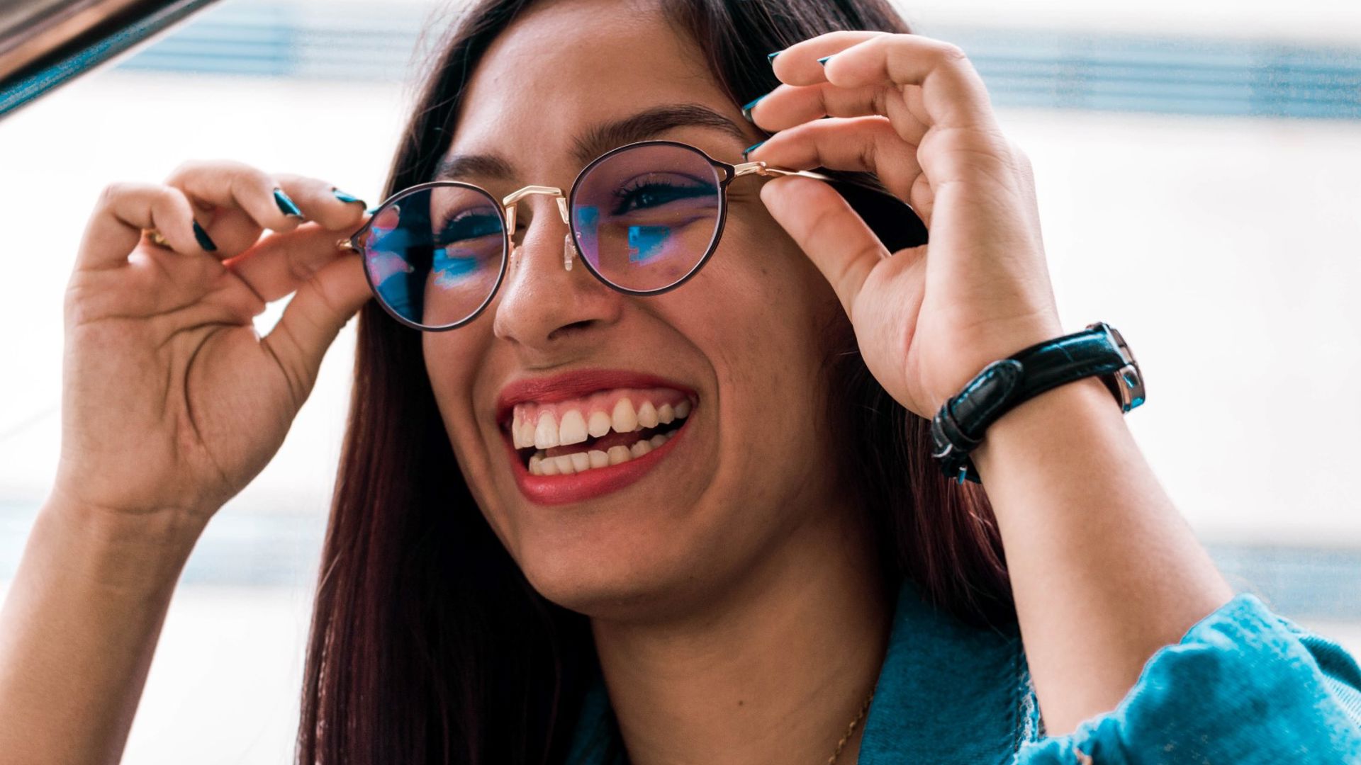 Woman trying on glasses that she got at GMHBA eye care