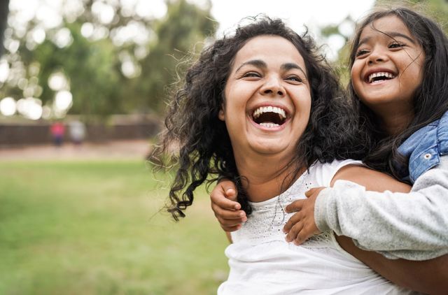 mother and duaghter smiling single parent health insurance