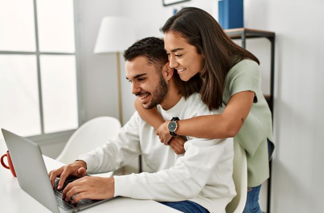 Couple completing their online rebate form for their health insurance