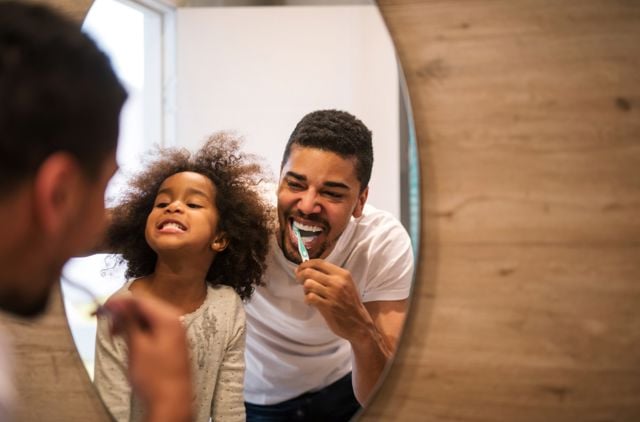 Father and daughter brushing