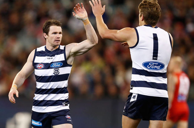 Two cats players high fiving