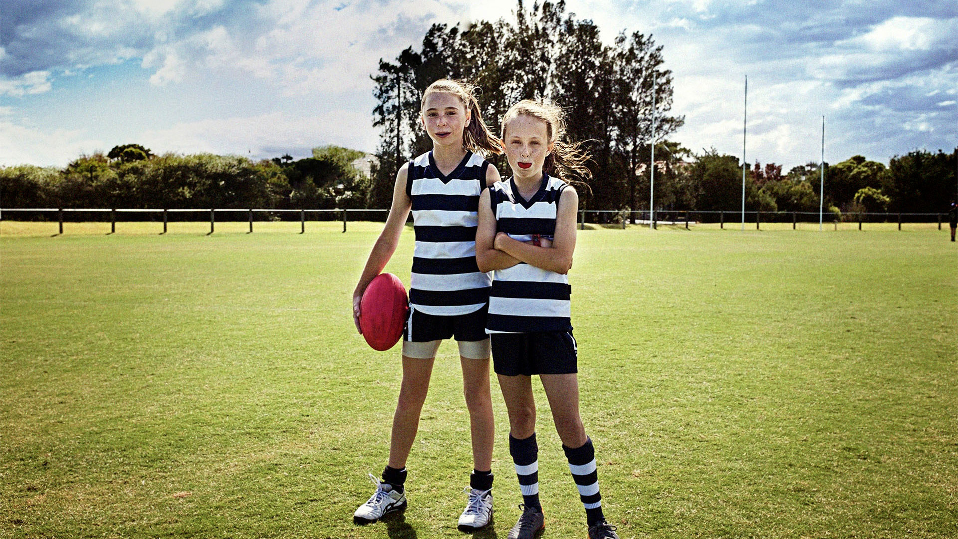 Young girls having a break during a game of AFL football