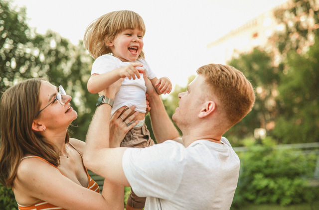 Young family with toddler playing in the sunshine.jpg