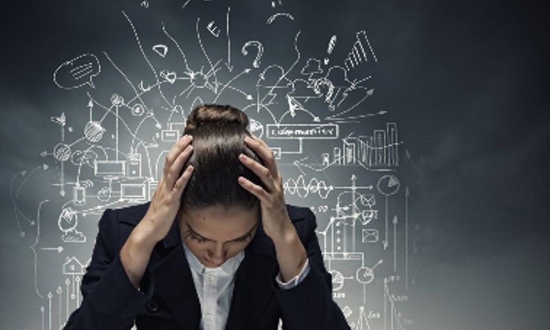 Stressed woman with her head in her hands