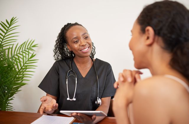 Female doctor talking to female patient