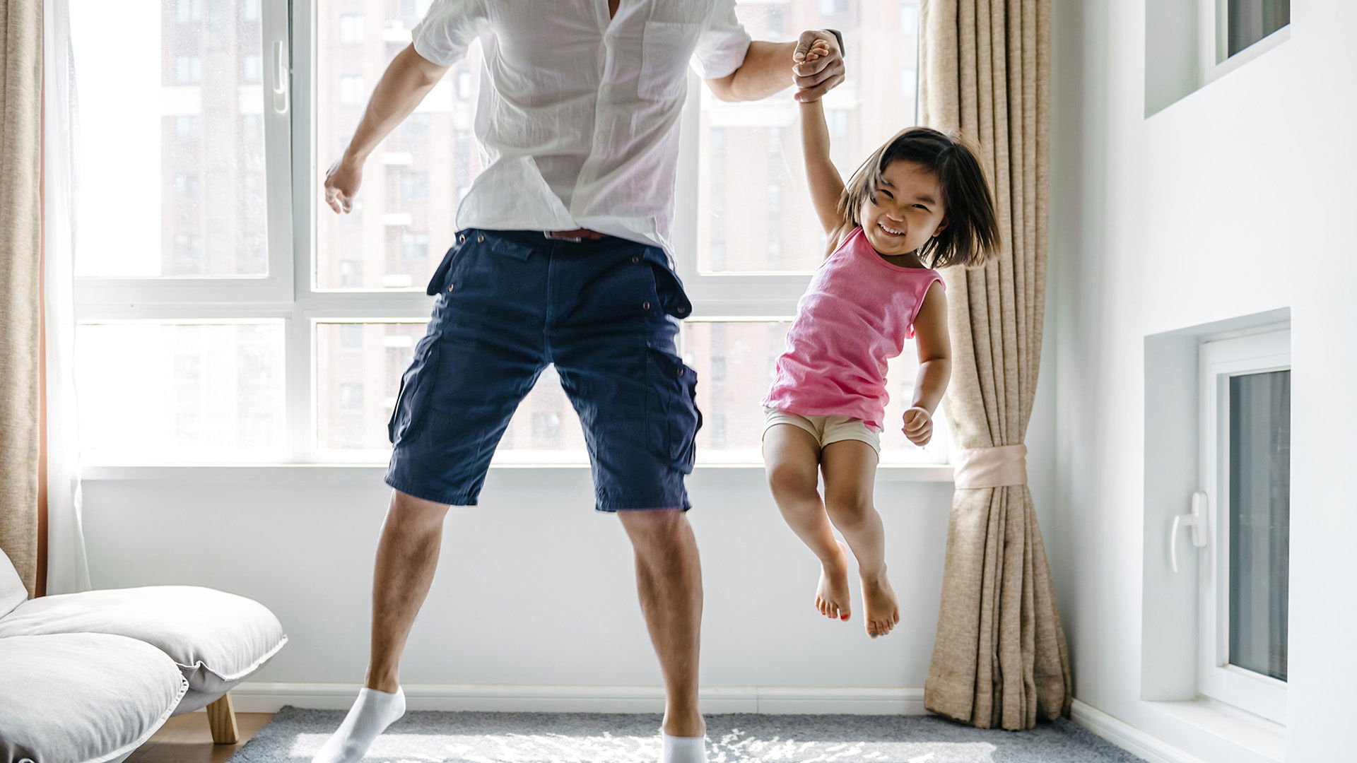 Dad having fun with daughter enjoying one month premium contribution.jpg