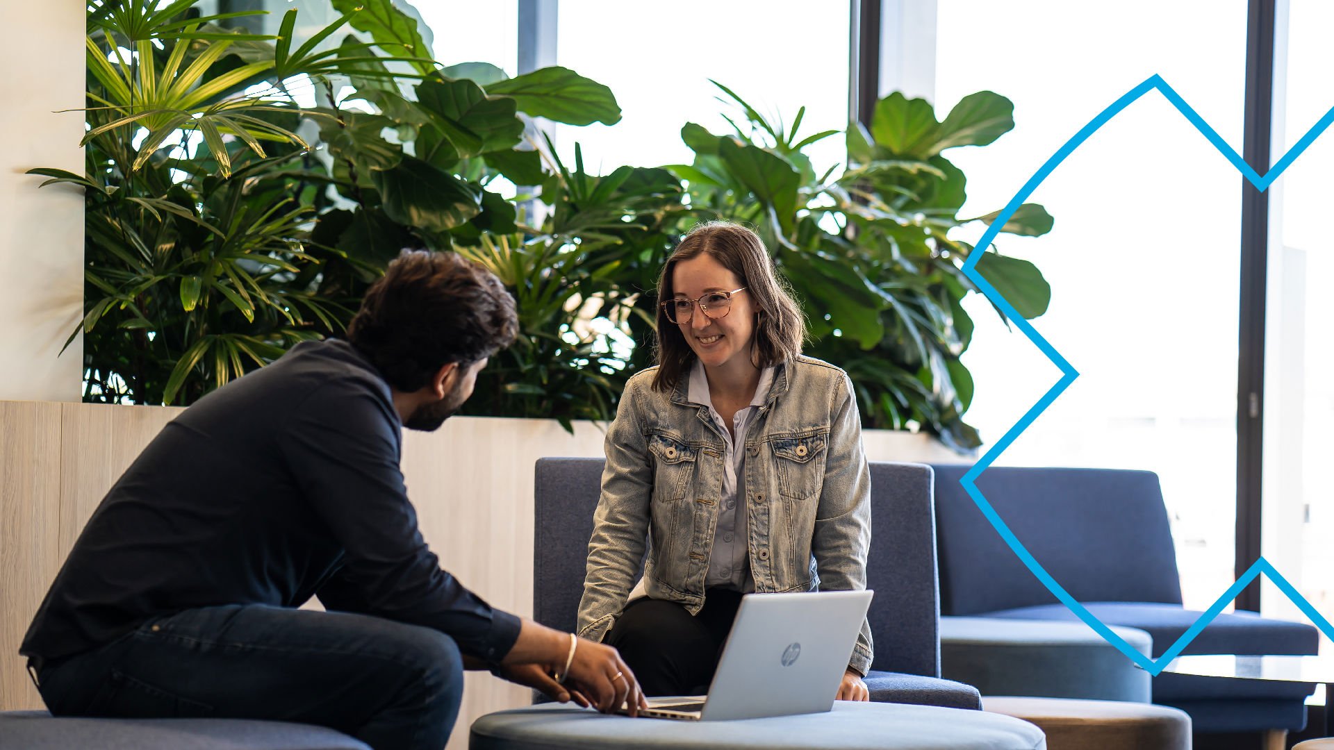 GMHBA careers - two employees chatting over a laptop