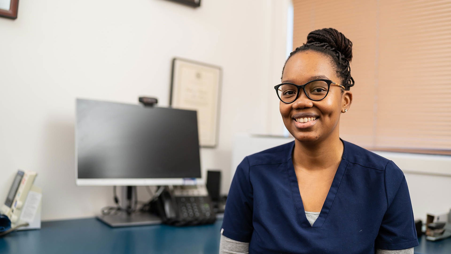 Female clinician sitting in medical office