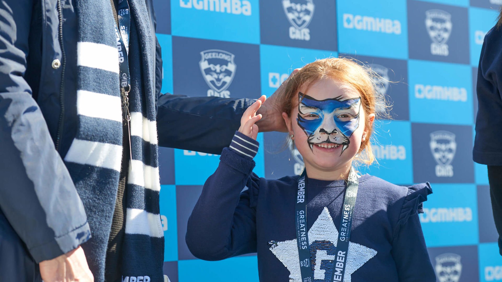 Little kid in full geelong cat makeup