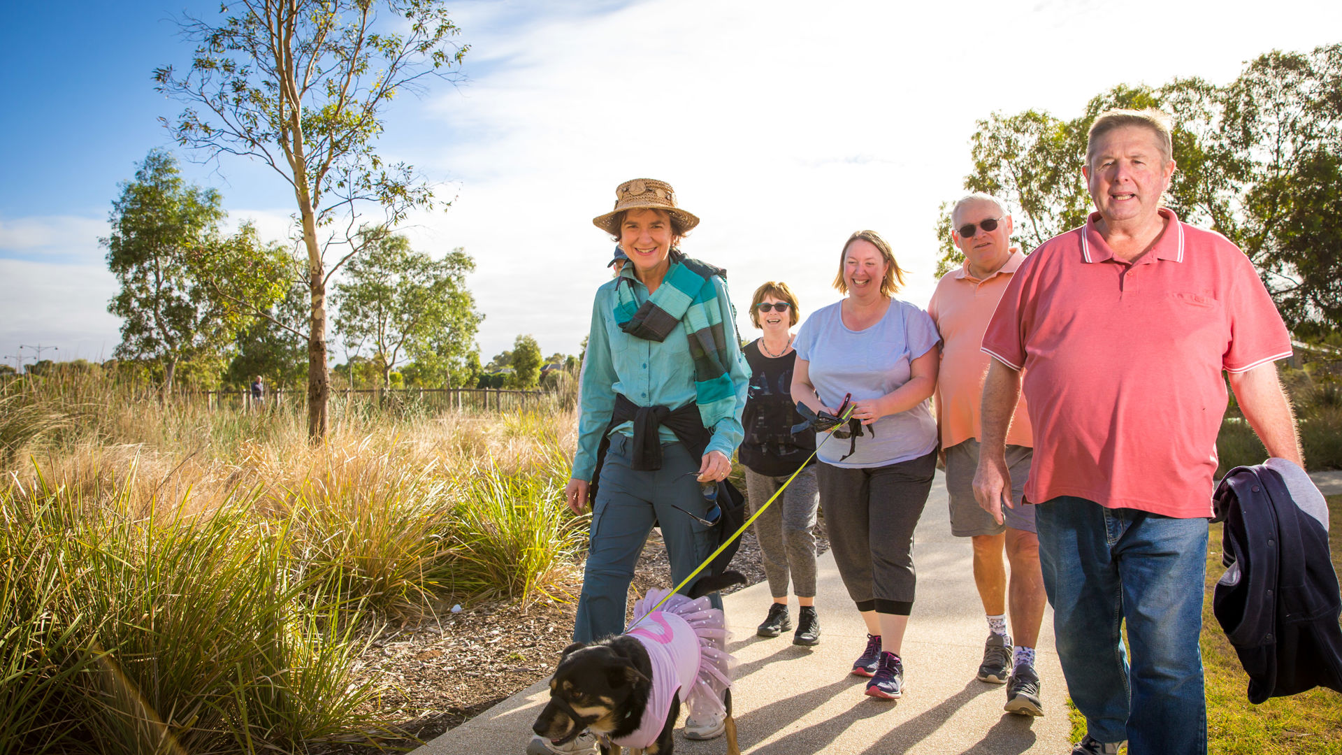 A variety of people walking together outside