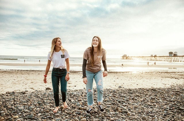Young Females on beach new to health Insurance
